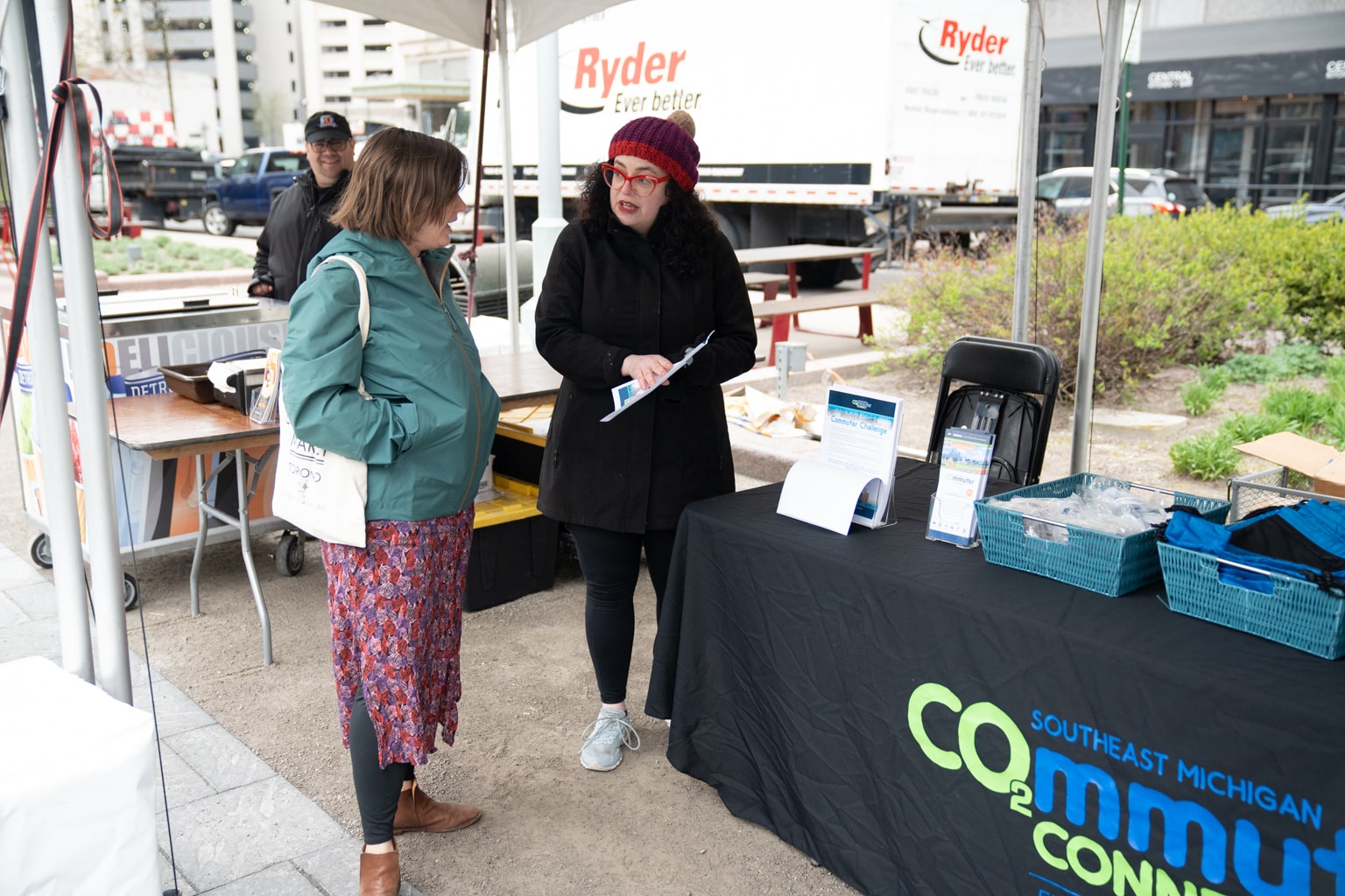 two people talking at commuter connect event display outside