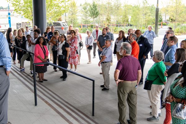 People gathered outside at a SEMCOG event for regional planning and transportation initiatives.