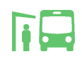 Green icon depicting a person standing at a bus stop next to a bus and shelter, symbolizing public transit or transportation access.