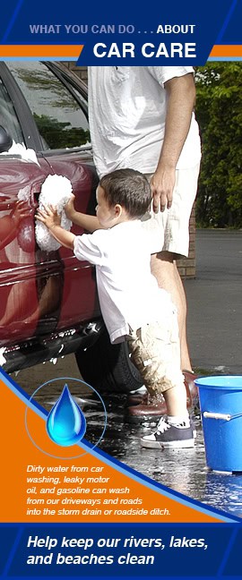 Informational flyer showing a young child washing a red car with help from an adult. A bucket and soapy water are on the ground nearby. Text explains how dirty water, motor oil, and gasoline from car washing can wash into storm drains and pollute waterways. A message at the bottom encourages keeping rivers, lakes, and beaches clean.