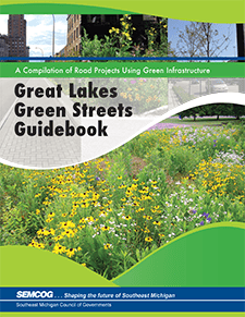 Cover of the Great Lakes Green Streets Guidebook by SEMCOG. A compilation of road projects using green infrastructure. The image shows a landscaped urban street with vibrant wildflowers and greenery.