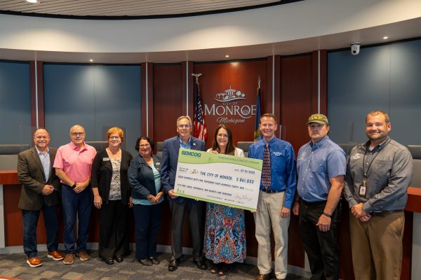 Group of people holding oversized check