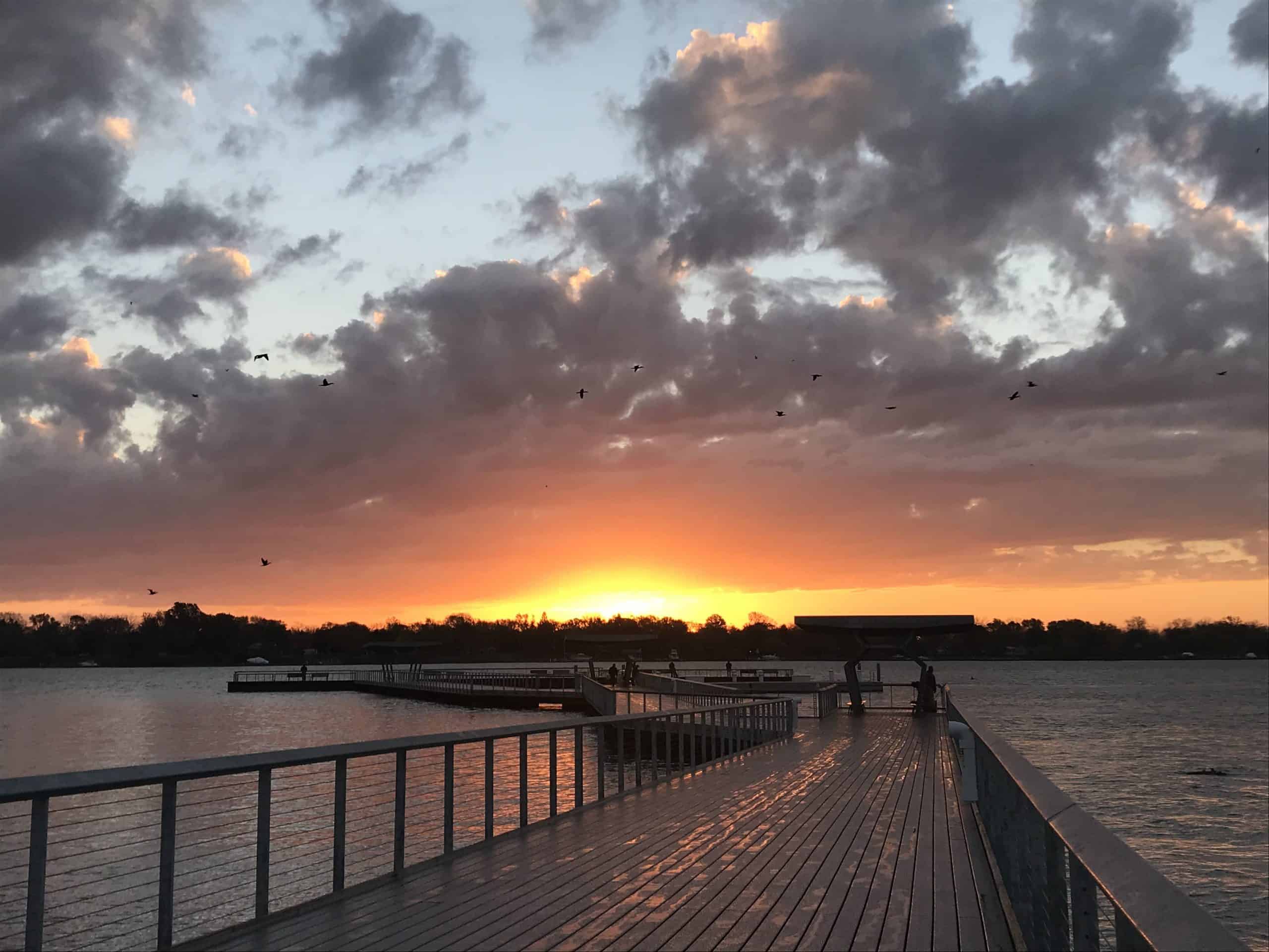 sunset at the end of water pier