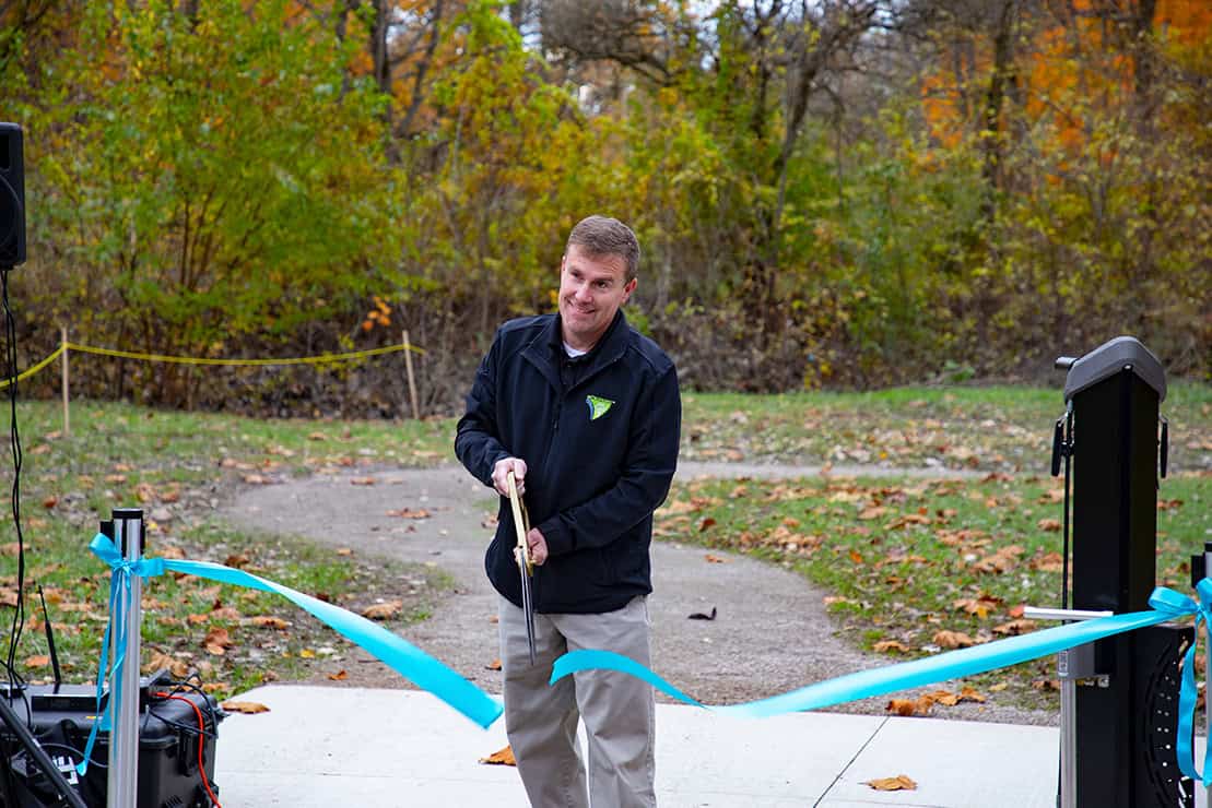 Jeff Linn, the Southern District Park Superintendent for Huron-Clinton Metroparks, cuts the ribbon celebrating new renovations finished at Lower Huron Metropark’s North Fishing site