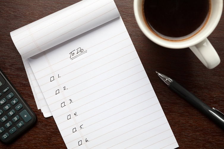 Numbered to do list next to a coffee mug
