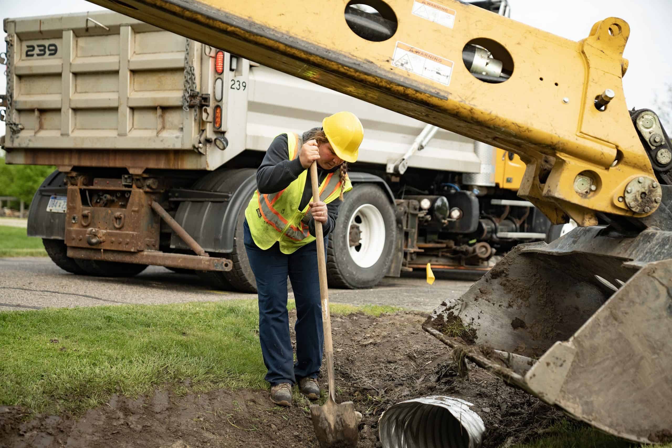 excavator truck digging dirt with water industry worker digging with shovel