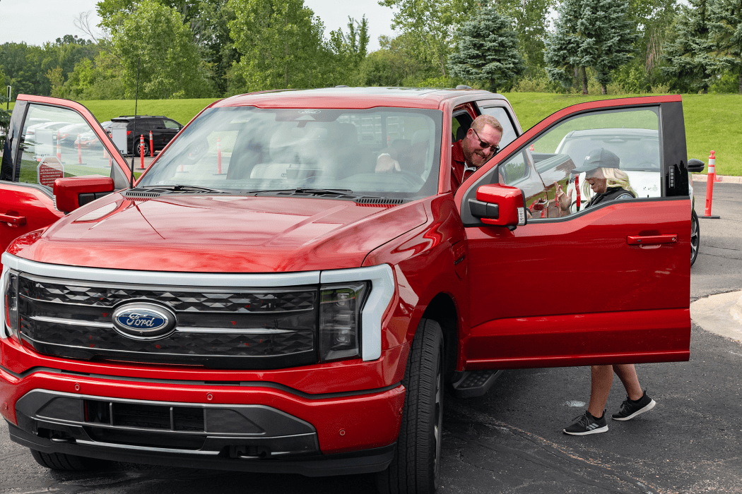 truck with two front doors open and people standing close by