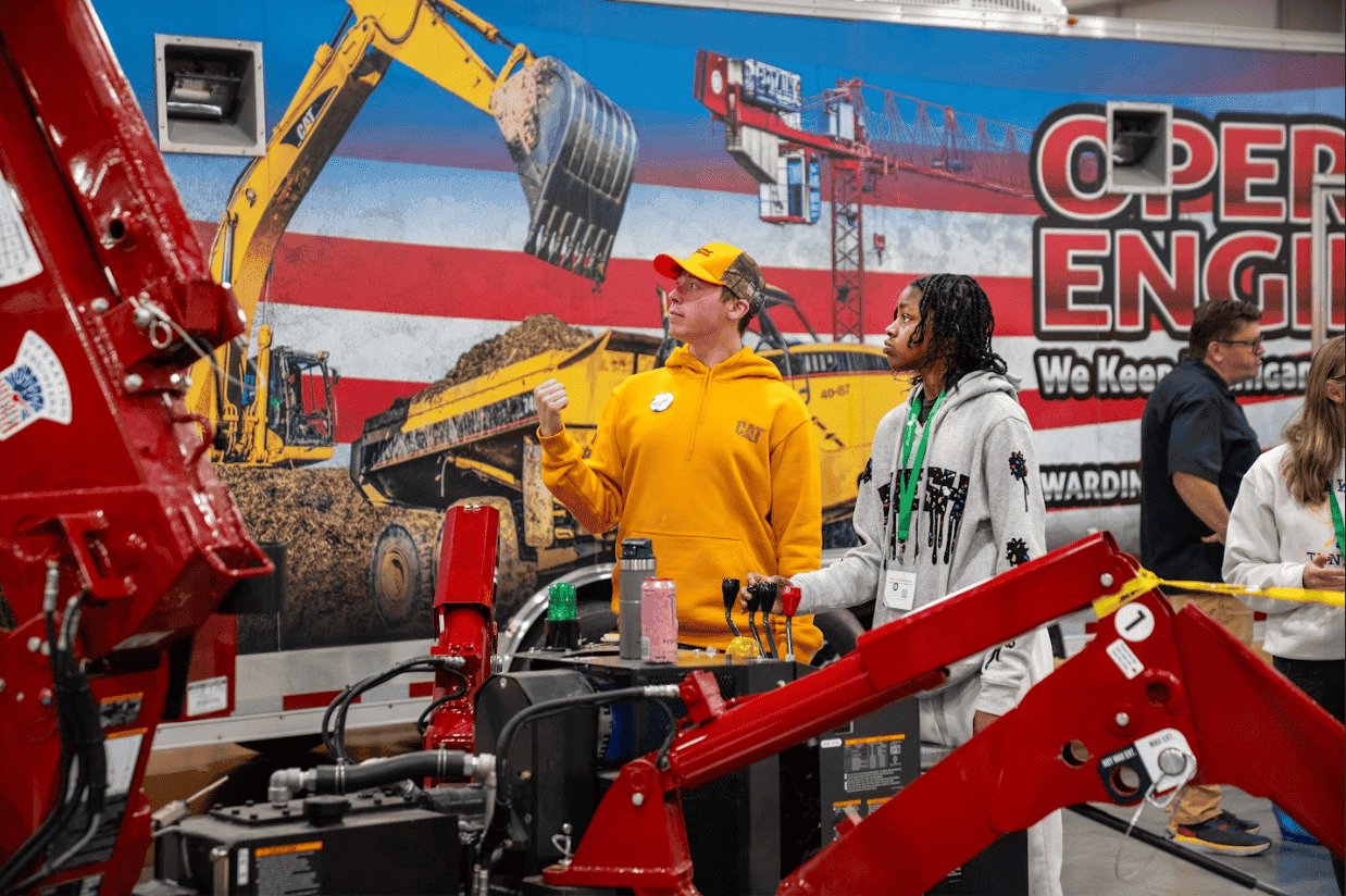 student looking at construction tools at an event