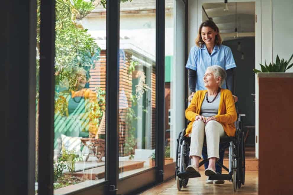medical professional assisting with woman in a wheelchair