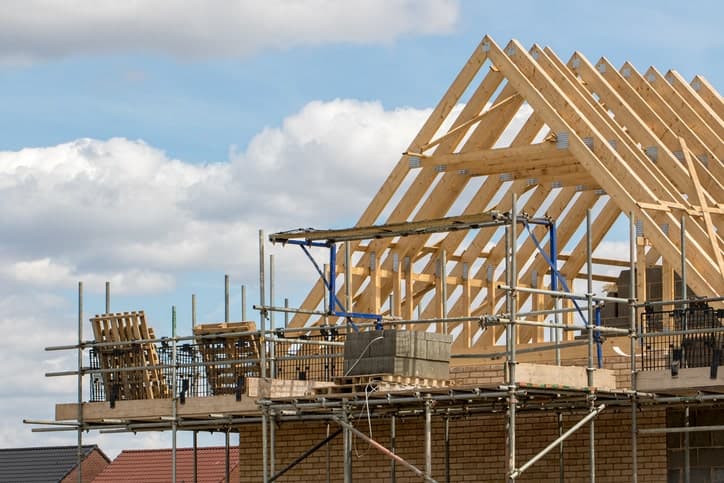 Timber framework of house roof trusses with scaffold