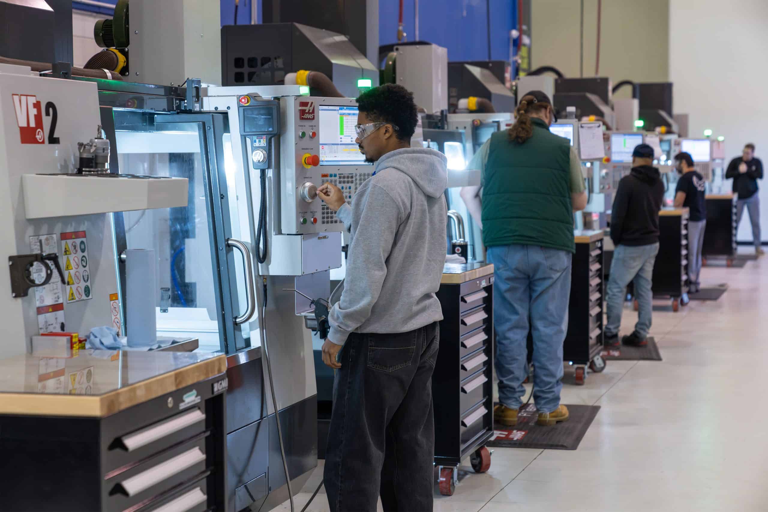 students using machinery and waring safety glasses