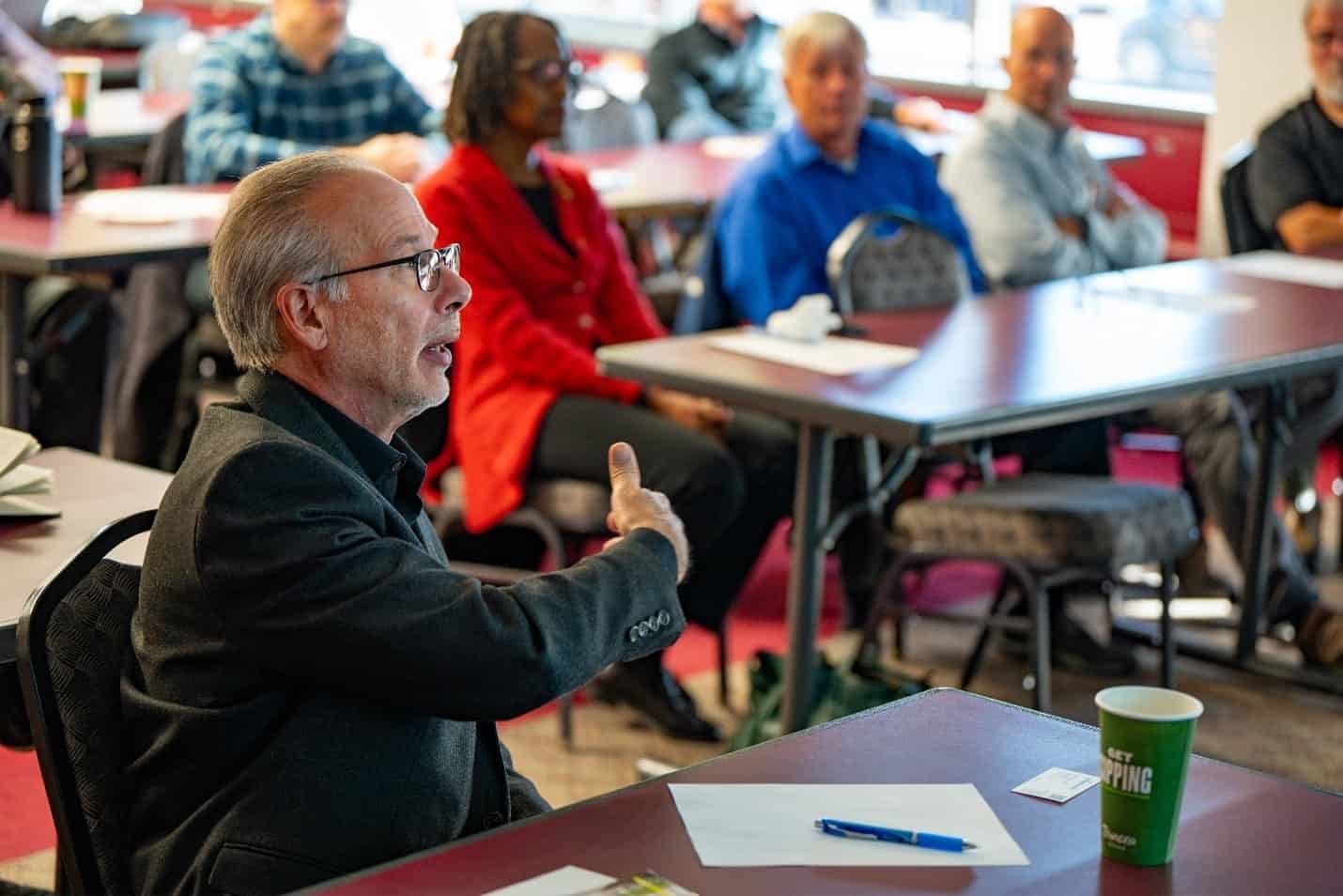 Meeting attendee, sitting and speaking