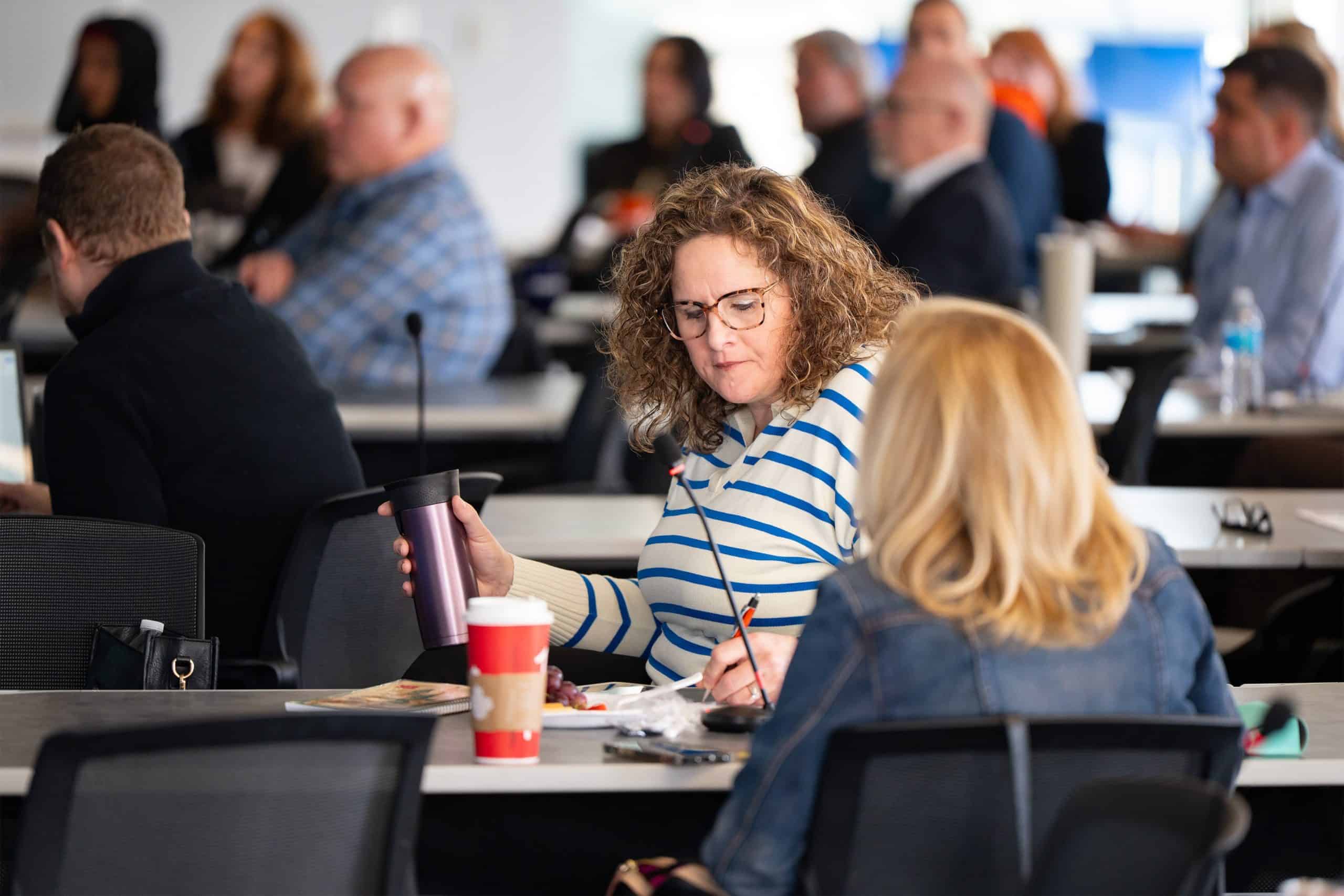 Attendee of session taking notes among meeting