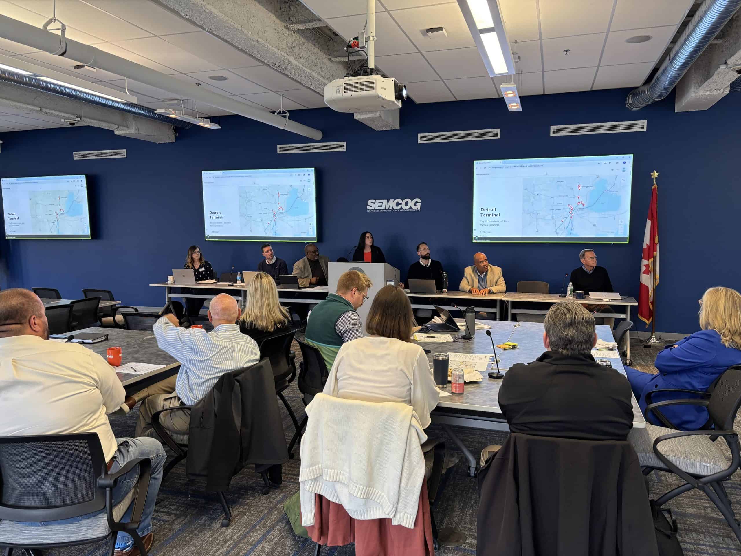 Urban planning meeting at SEMCOG with officials discussing transportation and infrastructure projects.