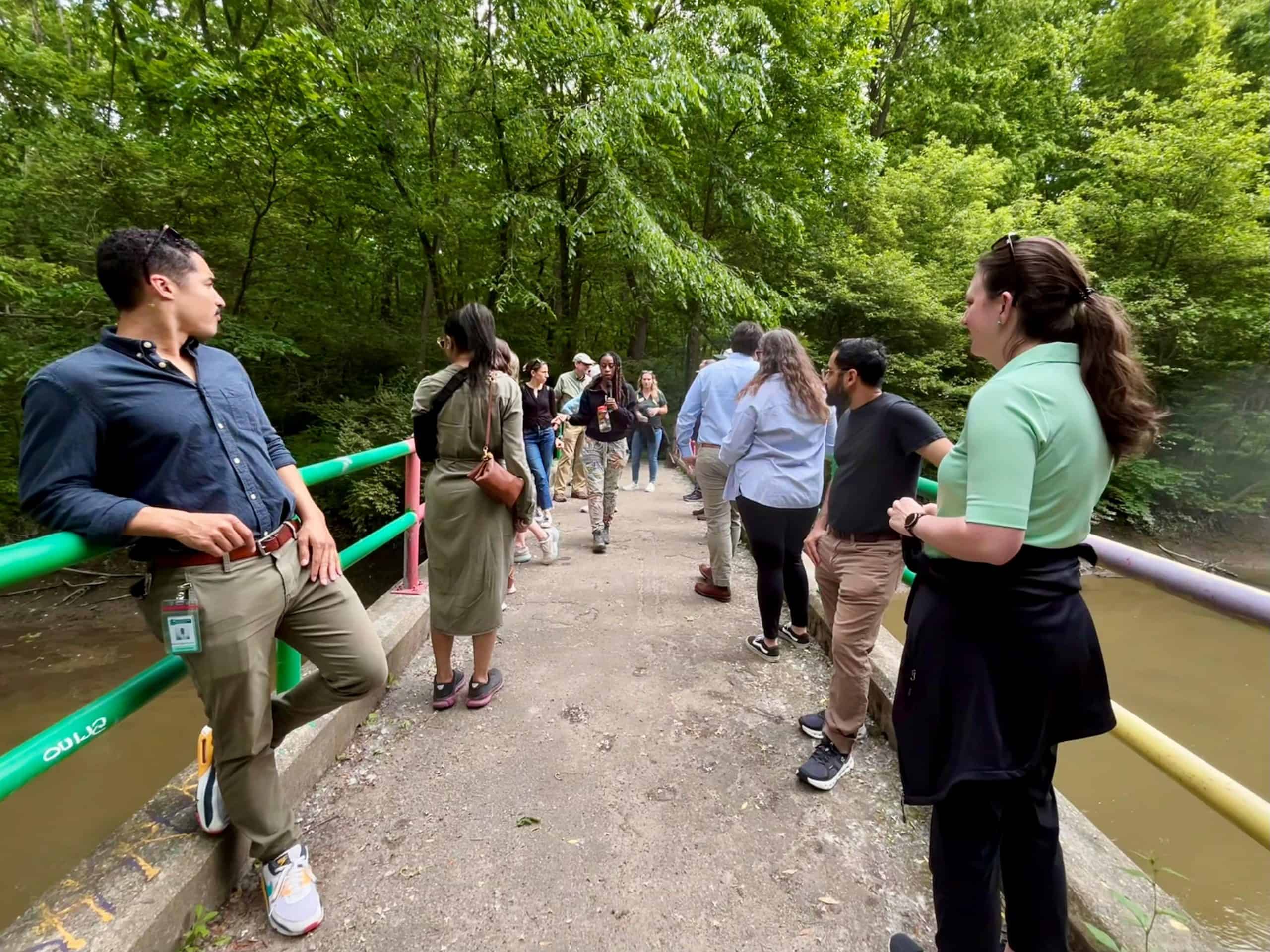 People standing on a bridge in eliza howell park