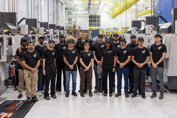 groups of individuals standing together inside of a factory