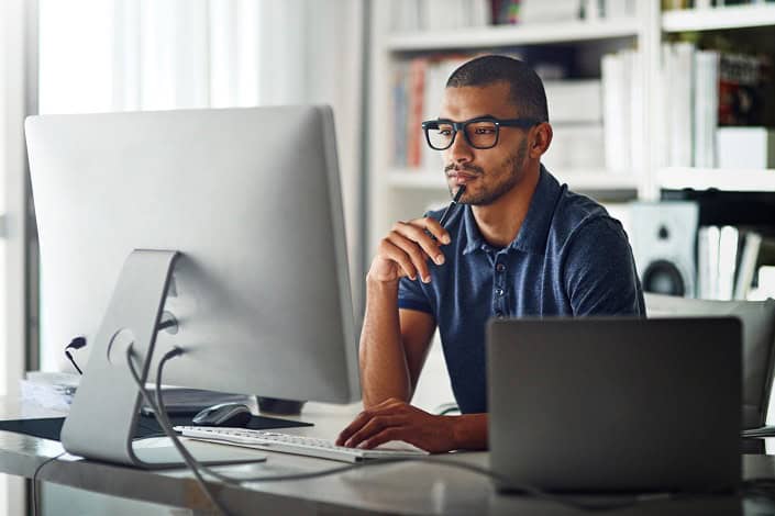 man focusing and looking at computer man focusing and looking at computer