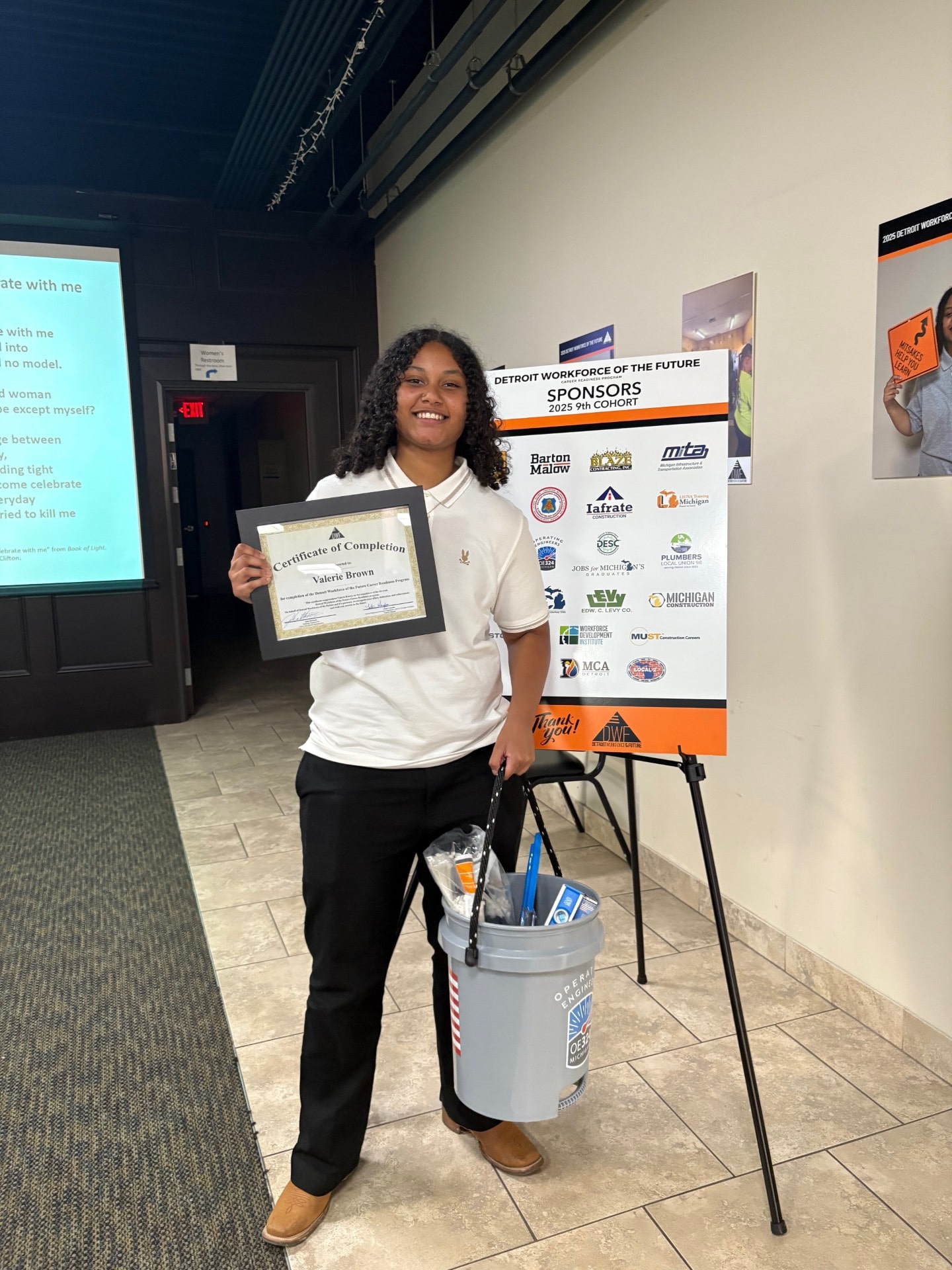 Valerie Brown with her certificate and the gift of tools from the sponsors