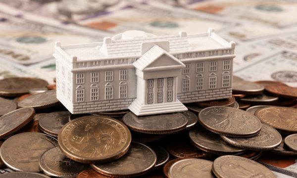 Miniature symbolic residence of the US President - White House and American coins and bills