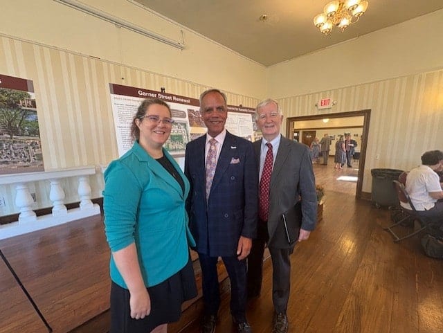 Rademacher, McDaniel, and Hoffman pose together at a regional planning event, standing in front of a SEMCOG-branded backdrop.