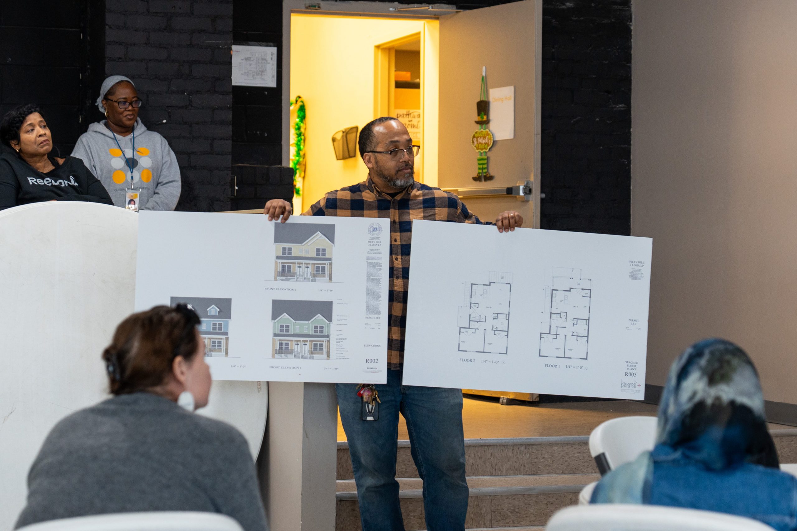 Illustration representing housing and neighborhood development themes, including homes and community buildings in Southeast Michigan.