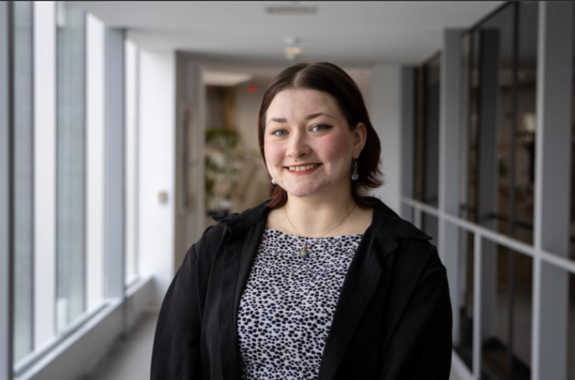 Person standing and smiling for professional headshot photo