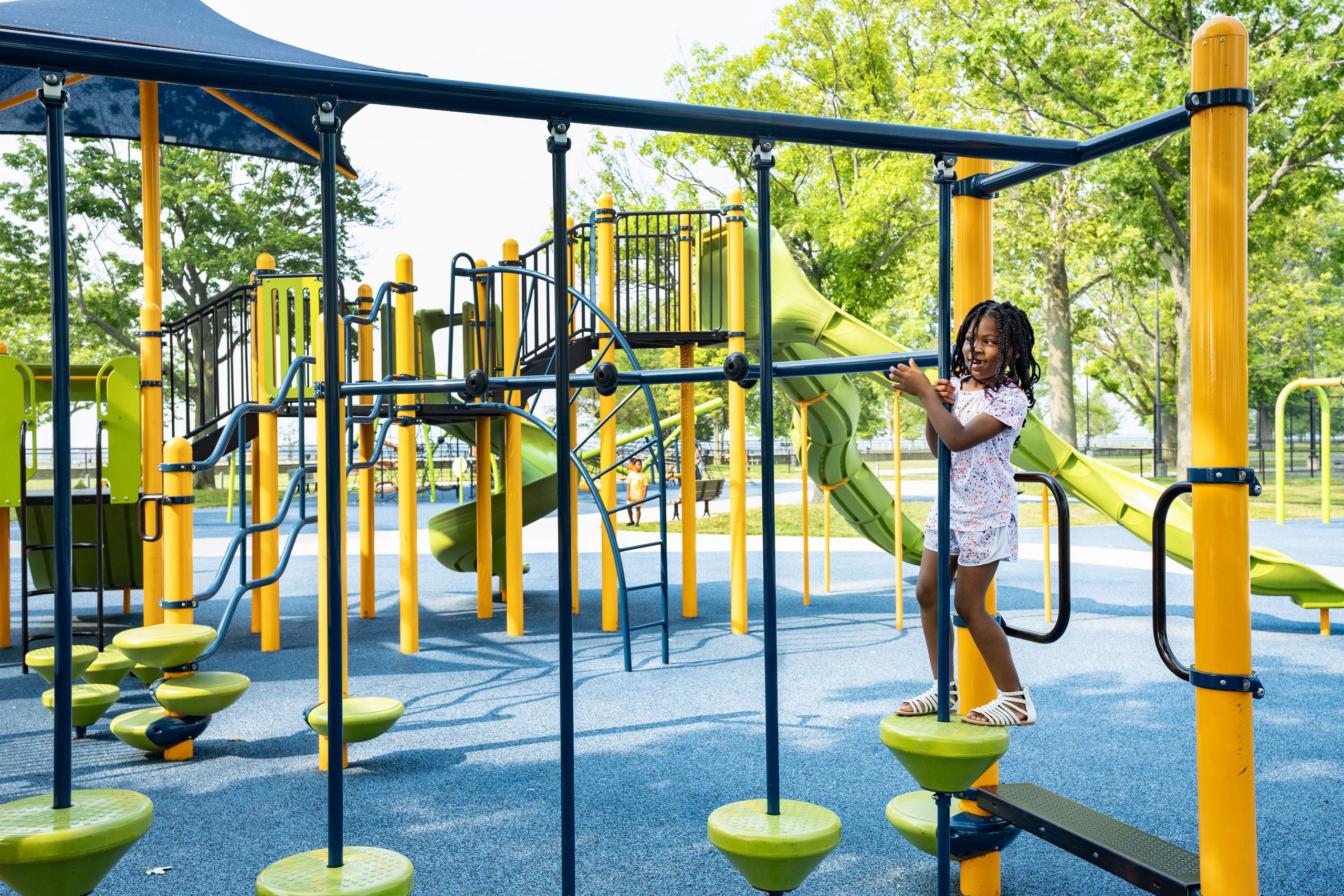 A child plays on playground equipment at Lake St. Clair Metropark.