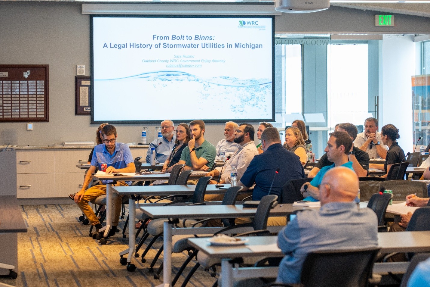 Attendees listen to a presentation on the legal history of stormwater utilities in Michigan during a conference session.